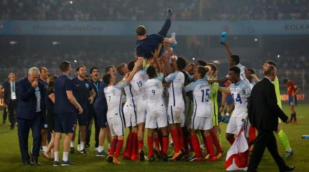 Soccer Football - FIFA Under 17 World Cup Final - England vs Spain  - Vivekananda Yuba Bharati Krirangan, Kolkata, India - October 28, 2017   England players lift manager Steve Cooper after winning the 2017 FIFA U-17 World Cup   REUTERS/Danish Siddiqui