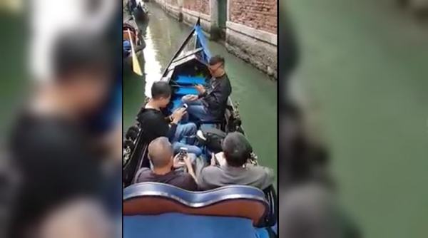 venice, venice gondola, gondola ride, tourist keep looking at phone, tourist busy with phone gondola, viral videos, indian express