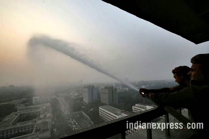 delhi pollution photos, ito water spray photos, water sprayed from building at ito pics, ito water sprinkled pictures, indian express