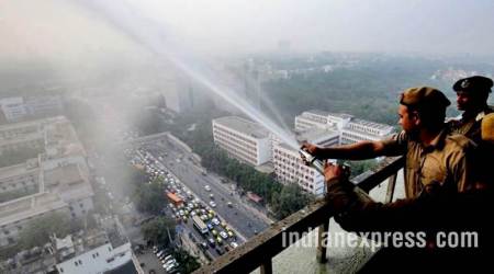 delhi pollution photos, ito water spray photos, water sprayed from building at ito pics, ito water sprinkled pictures, indian express