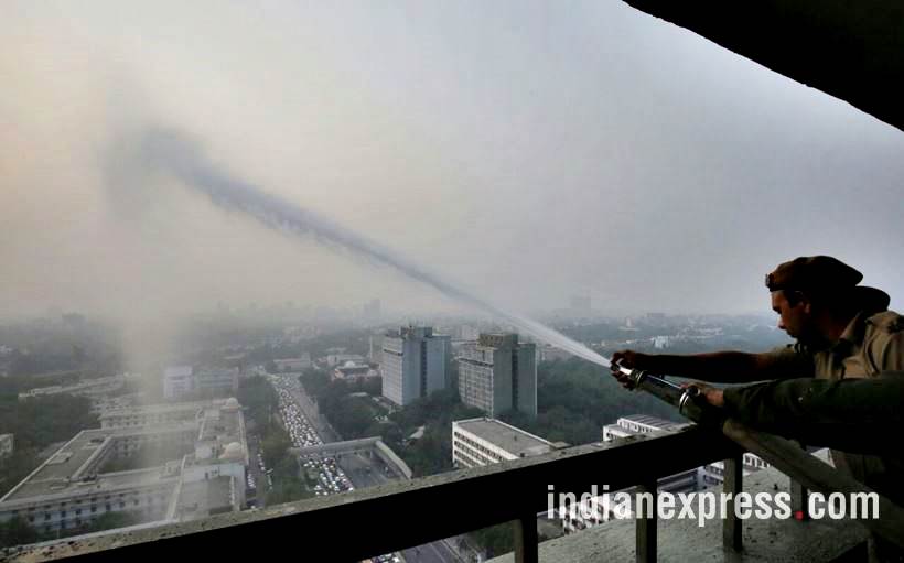 delhi pollution photos, ito water spray photos, water sprayed from building at ito pics, ito water sprinkled pictures, indian express