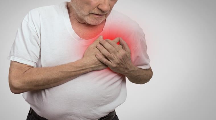 Photo of an older man clutching his heart, indication cardiovascular issues. Psychedelics can pose provlems in older adults with cardiovascular disease.