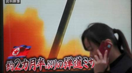 A woman walks past a TV screen broadcasting news of North Korea's missile launch, in Tokyo, Wednesday, Nov. 29, 2017. After 2 ½ months of relative peace, North Korea launched its most powerful weapon yet early Wednesday, a presumed intercontinental ballistic missile that could put Washington and the entire eastern U.S. seaboard within range. The letters at bottom read " Ballistic missile after 2 ½ months." (AP Photo/Shizuo Kambayashi)