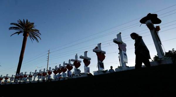 Las Vegas pauses but looks ahead a year after mass shooting