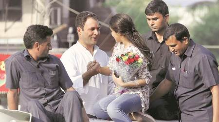 Bharuch: Congress vice-president Rahul Gandhi being greeted by a young supporter during his road show in Bharuch on Wednesday. PTI Photo     (PTI11_1_2017_000100B)
