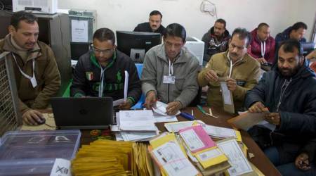 Election officials count votes received by post at a poll counting center in Dharmsala, India, Monday, Dec. 18, 2017. Voting for local elections in this northern Indian state of Himachal Pradesh was held on Nov. 9. (AP Photo/Ashwini Bhatia)