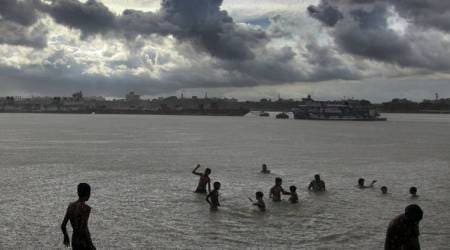 People enjoying a bath during the rain in river (Hooghly) Ganges in Kolkata, on June 27, 2016. Express photo by Partha Paul.