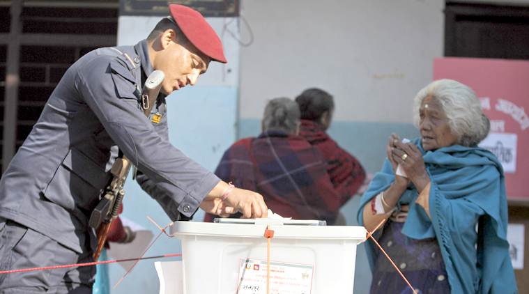 A Nepalese policeman helps a woman to cast her vote during the legislative elections in Thimi, Bhaktapur, Nepal, Thursday, Dec. 7, 2017. Millions of people were voting in southern Nepal on Thursday in the final phase of mostly peaceful elections for members of the national and provincial assemblies. (AP Photo/Niranjan Shrestha)