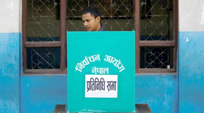A man cast his vote during the parliamentary and provincial elections in Thimi, Nepal December 7, 2017. REUTERS/Navesh Chitrakar