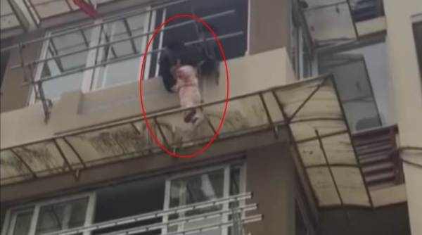 girl saved by stranger, girl hanging from window, man saves girl hanging from window, viral video, indian express, indian express news