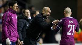 Manchester City manager Pep Guardiola talks with David Silva