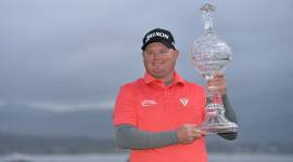 Ted Potter Jr poses with the trophy after winning Pebble Beach