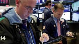 Traders Kevin Walsh, left, and Robert Charmak work on the floor of the New York Stock Exchange at the close of trading, Monday, Feb. 5, 2018. The Dow Jones industrial average plunged more than 1,100 points Monday as stocks took their worst loss in six and a half years. (AP Photo/Richard Drew)
