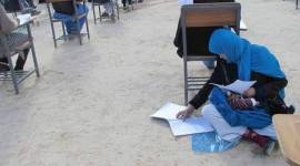 afghan woman exam_fb_759 Afghanistan woman writing exam with a baby, Afghanistan woman writing exam, Afghanistan woman viral picture