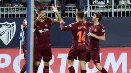 Barcelona players celebrate a goal against Malaga