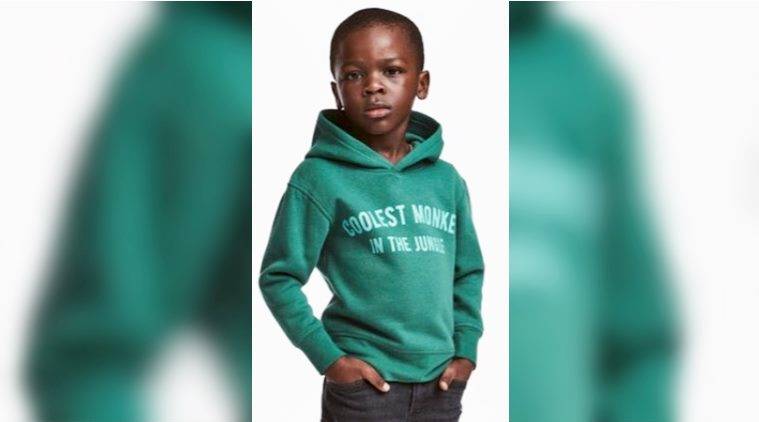 h and m ad. with black kid in green sweatshirt
