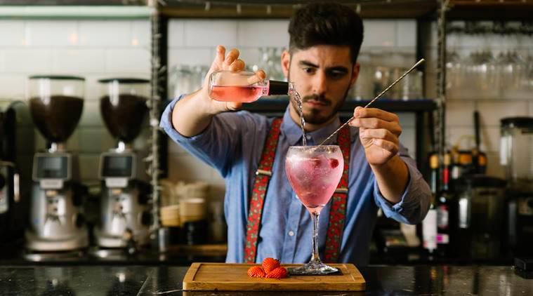 Bartender-as-chemist. Brix refractometer in hand.