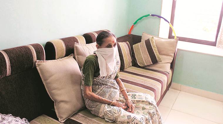 woman covers her mouth to prevent herself from inhaling toxic gas 