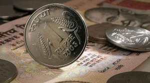 Rupee slips 8 paise to 69.73 against US dollar, Sensex, Nifty start on a cautious note