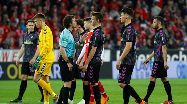 Freiburg's Janik Haberer speaks with referee Guido Winkmann after a penalty is awarded to Mainz