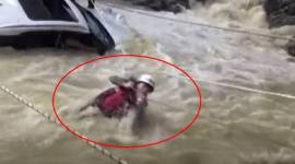 a woman stuck in flooded river, woman stuck in river in china, accident video, china viral video