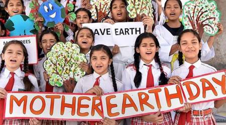 Bikaner: School children display banners and placards with social messages for saving the environment on the eve of 'World Earth Day' in Bikaner on Saturday. (PTI)
