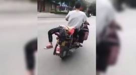 Father forces girl for school_YB_759 father forces girl to school, father ties girl on the bike girl refused to go to school, girl refused to school, father tie her on bike, viral china video, China social media viral, indian express