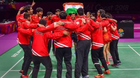 Gold Coast: India badminton players hold tricolour as they celebrate India's win in mixed-team badminton event final at Commonwealth Games 2018 in Gold Coast, on Monday.  PTI Photo by Manvender Vashist(PTI4_9_2018_000163B)