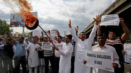 Activists of National Panther party burn tyres and shout slogans during a protest in support of various demands, including deportation of Rohingyas and Bangladeshi nationals from Jammu, and a CBI probe into the rape and murder of an eight-year-old girl in Kathua on January, Jammu April 11, 2018. REUTERS/Mukesh Gupta