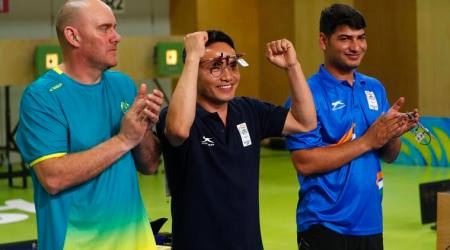 Shooting - Gold Coast 2018 Commonwealth Games - Men's 10m Air Pistol - Final - Belmont Shooting Centre - Brisbane, Australia - April 9, 2018. Gold medallist Jitu Rai of India celebrates flanked by silver medallist Kerry Bell and bronze medallist Om Mitharval. REUTERS/Eddie Safarik