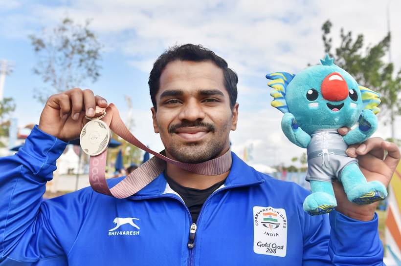 P Gururaja poses with his silver medal
