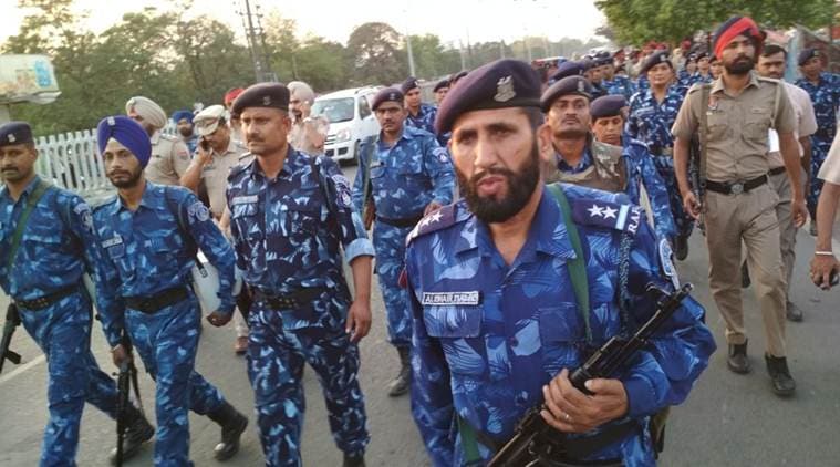Police personnel carry out a flag march in Ludhiana on Sunday. (Express photo/Gurmeet Singh)