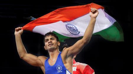 Gold Coast: India's Rahul Aware holds tricolour after winning the match against Canada's Steven Takahashi in the men's freestyle 57kg wrestling final at the Commonwealth Games 2018 in Gold Coast, on Thursday.  PTI Photo by Manvender Vashist(PTI4_12_2018_000074B)