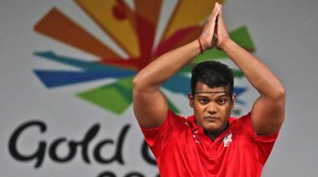 India's men's 85Kg Weightlifting Gold medalist Rahul Venkat Ragala greets spectators during a medal ceremony at the Commonwealth Games in Gold Coast, Australia, Saturday, April 7, 2018. (AP Photo/Manish Swarup)
