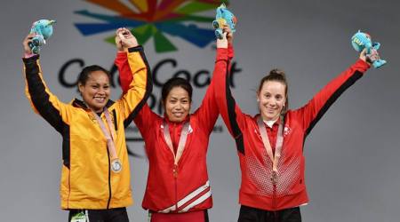 Gold Coast: Gold medalist Indian weightlifter Sanjita Chanu, Silver medalist Papua New Guinean weightlifter, Dika Loa Toua and Bronze medalist Canadian weightlifter Rachel Leblanc-Bazinet during the medal ceremony of women's 53kg Weightlifting event during the Commonwealth  Games 2018 in Gold Coast, on Friday.  PTI Photo by Manvender Vashist (PTI4_6_2018_000016B)
