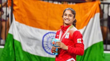 Gold Coast: Gold medalist India's Vinesh Phogat poses for pictures during the medal ceremony of WFS50kg wrestling Nordic at the Commonwealth Games 2018 in Gold Coast, Australia on Saturday. PTI Photo by Manvender Vashist   (PTI4_14_2018_000079A)