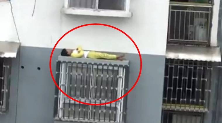 boy sleeping on the window roof, child sleeping on the roof, China video, china viral video, boy sleeping on window ledge, chinese kid sleeping on window ledge, Indian express, Indian express trending news
