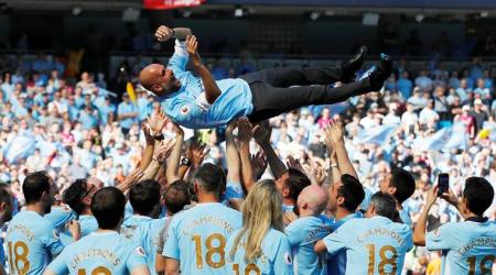 Soccer Football - Premier League - Manchester City vs Huddersfield Town - Etihad Stadium, Manchester, Britain - May 6, 2018   Manchester City manager Pep Guardiola and their players and staff celebrate winning the premier league title   Action Images via Reuters/Carl Recine    EDITORIAL USE ONLY. No use with unauthorized audio, video, data, fixture lists, club/league logos or "live" services. Online in-match use limited to 75 images, no video emulation. No use in betting, games or single club/league/player publications.  Please contact your account representative for further details.     TPX IMAGES OF THE DAY