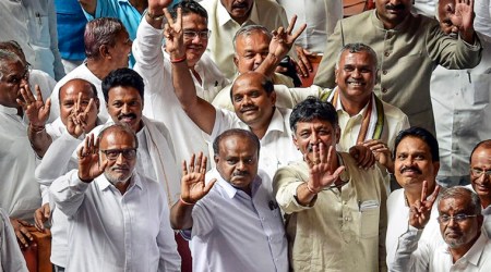 Karnataka Chief Minister H D Kumaraswamy, with other JD(S) and Congress leaders, waves to the media after his coalition government won the trust vote by voice vote, at Vidhana Soudha. (PTI)