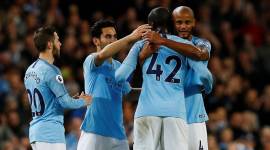 Manchester City's Yaya Toure hugs Vincent Kompany (R), Ilkay Gundogan (2nd L) and Bernardo Silva (L) as he is substituted off against Brighton