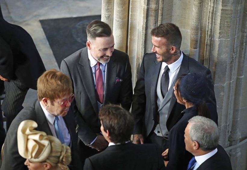 David and Victoria Beckham talk with Sir Elton John at royal wedding