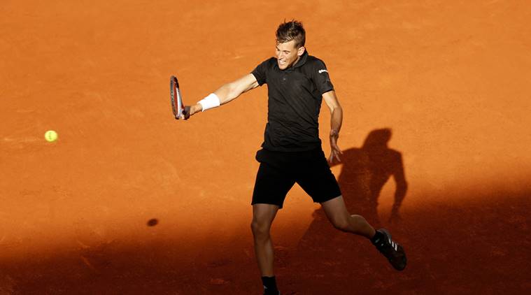 Dominic Thiem hits a backhand return to Rafael Nadal during a Madrid Open tennis tournament match in Madrid, Spain