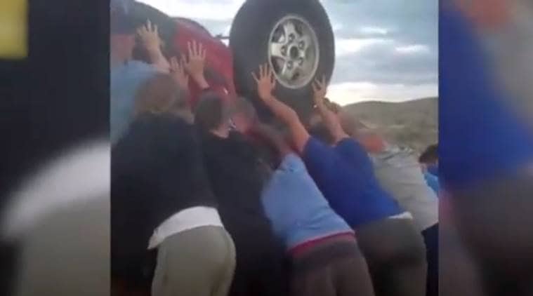car crash video, teenagers save couple from car crash, football team saves couple, car crash rescue by teenage boys, viral video, indian express, indian express news