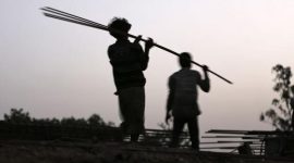 Labourers carry iron rods at the construction site of a flyover on the outskirts of the western Indian city of Ahmedabad Govt set to relax no-construction zone norm around Maharashtra jails