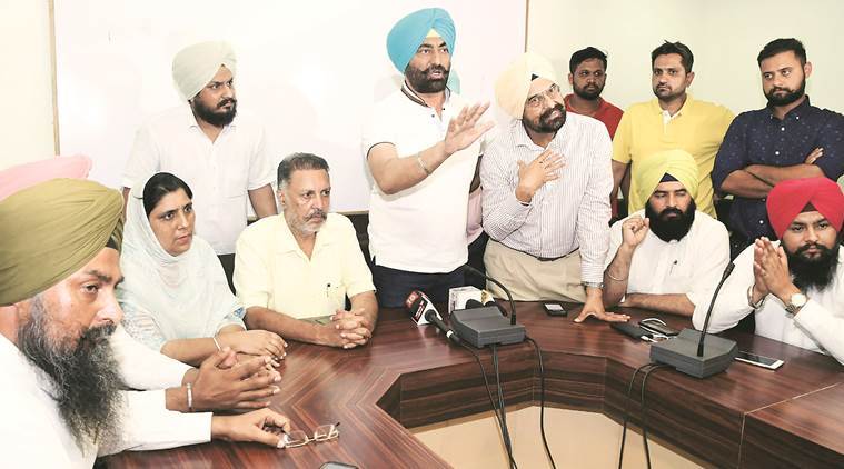 Sukhpal Singh Khaira and Balbir Singh (sitting beside Khaira) with other AAP leaders during a press conference in Chandigarh Thursday. (Express photo)
