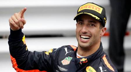 Red Bull driver Daniel Ricciardo of Australia celebrates winning the Formula One race, at the Monaco racetrack, in Monaco