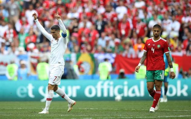 Portugal's Cristiano Ronaldo celebrates as Morocco's Manuel da Costa looks dejected after the match
