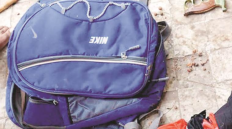 Police recovered a bag containing seven sharp-edged weapons and a liquid mixture of chilli powder from a terrace adjacent to the school building. (Express photo/Bhupendra Rana)