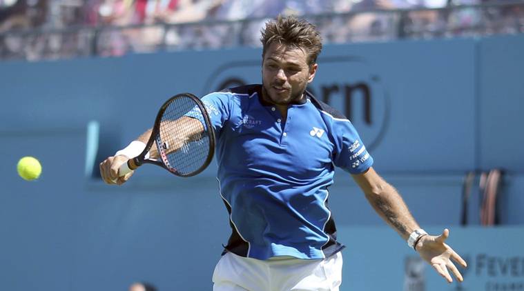 Switzerland's Stan Wawrinka returns a shot during his match against Britain's Cameron Norrie on day one of the Queen's Club Championship at the Queens Club, in London