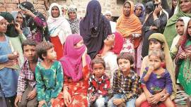 Akbar’s wife with their children. (Express photo/Hamza Khan)